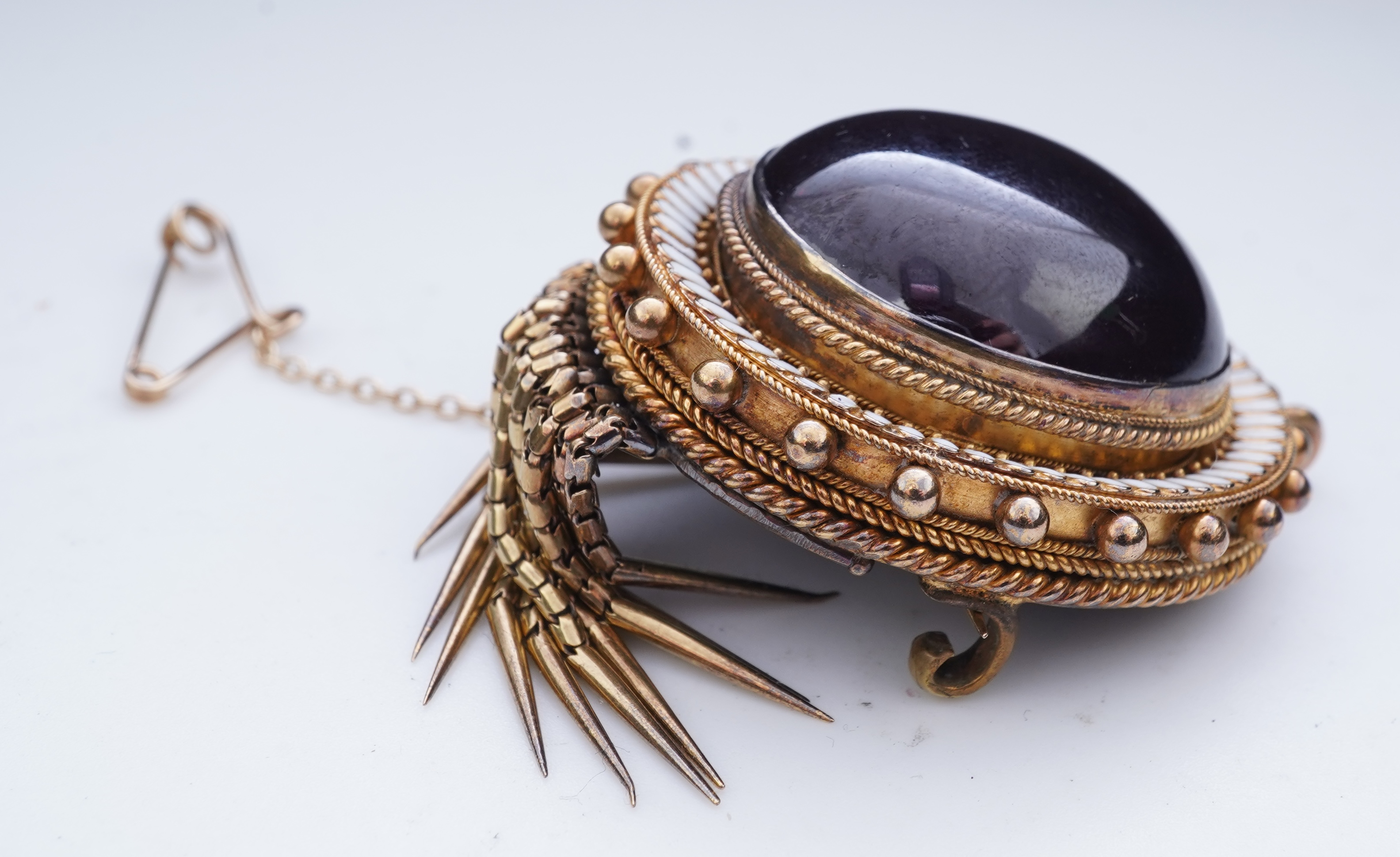 A Victorian garnet and enamel brooch, mid 19th century